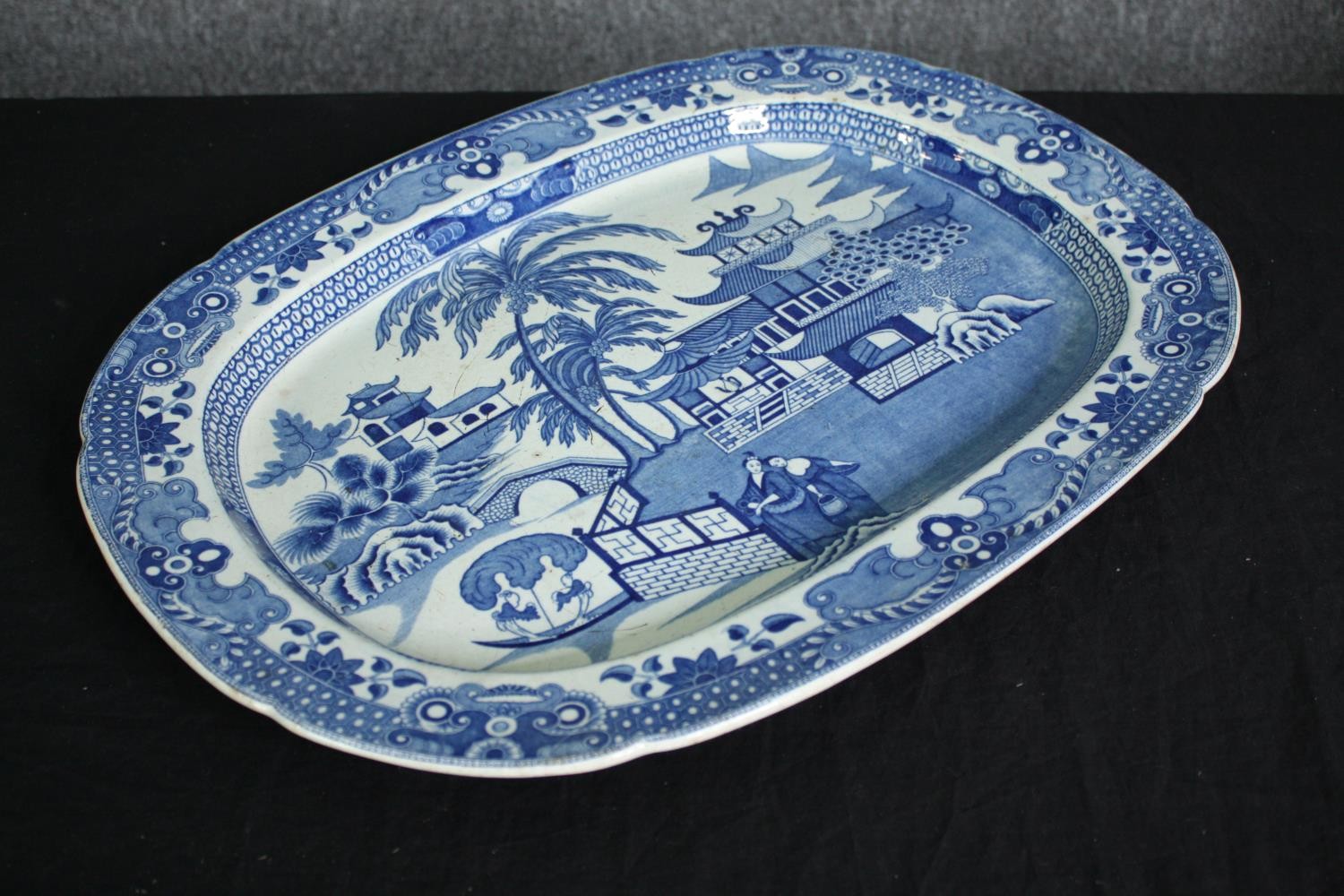 A large 19th century blue and white transfer printed serving platter with oriental figures in a - Image 2 of 5