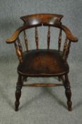 A 19th century elm smoker's bow back desk chair.