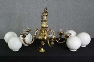 A six branch Dutch style brass chandelier with milk glass shades. H.60 Dia.80cm.