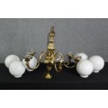 A six branch Dutch style brass chandelier with milk glass shades. H.60 Dia.80cm.