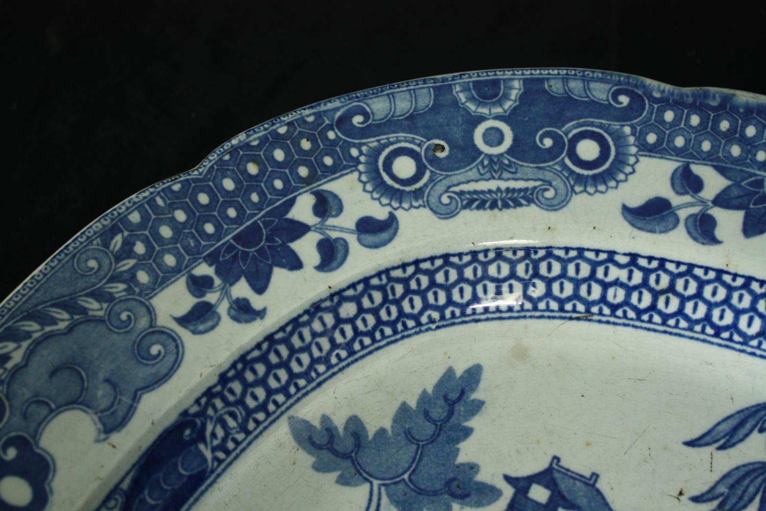 A large 19th century blue and white transfer printed serving platter with oriental figures in a - Image 4 of 5