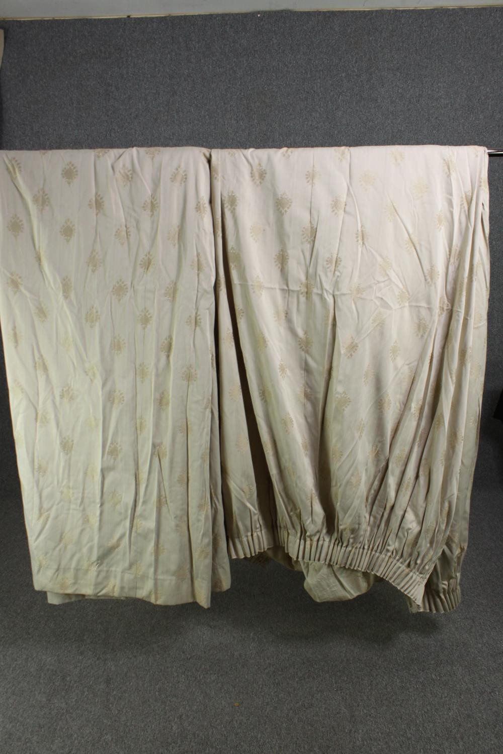 A pair of beige silk mix fully lined curtains with Indian motif. L.230 W.300cm. (each).