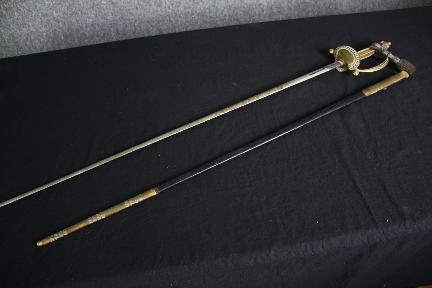 A 19th century officer's dress sword with dress knot and etched blade in brass mounted leather - Image 5 of 6