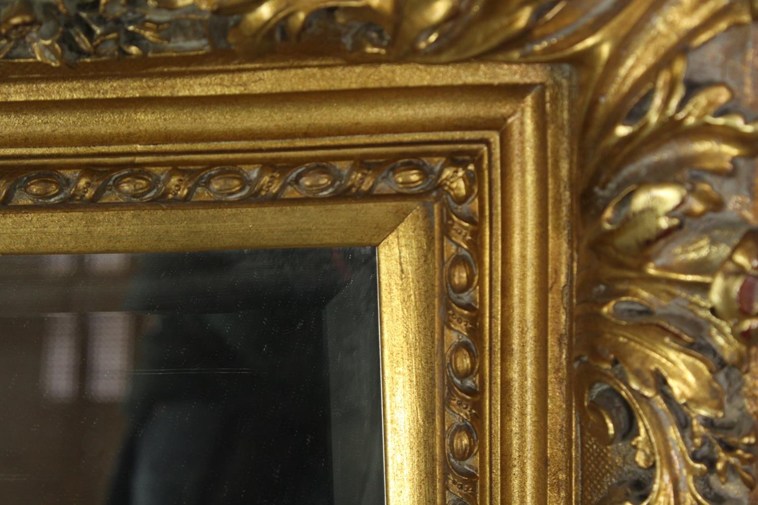 A giltwood and gesso wall mirror with foliate decoration and bevelled plate. H.91 W.120cm. - Image 6 of 7