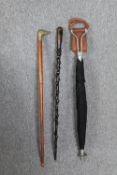 A vintage shooting stick / umbrella along with two walking canes. L.94cm. (largest).