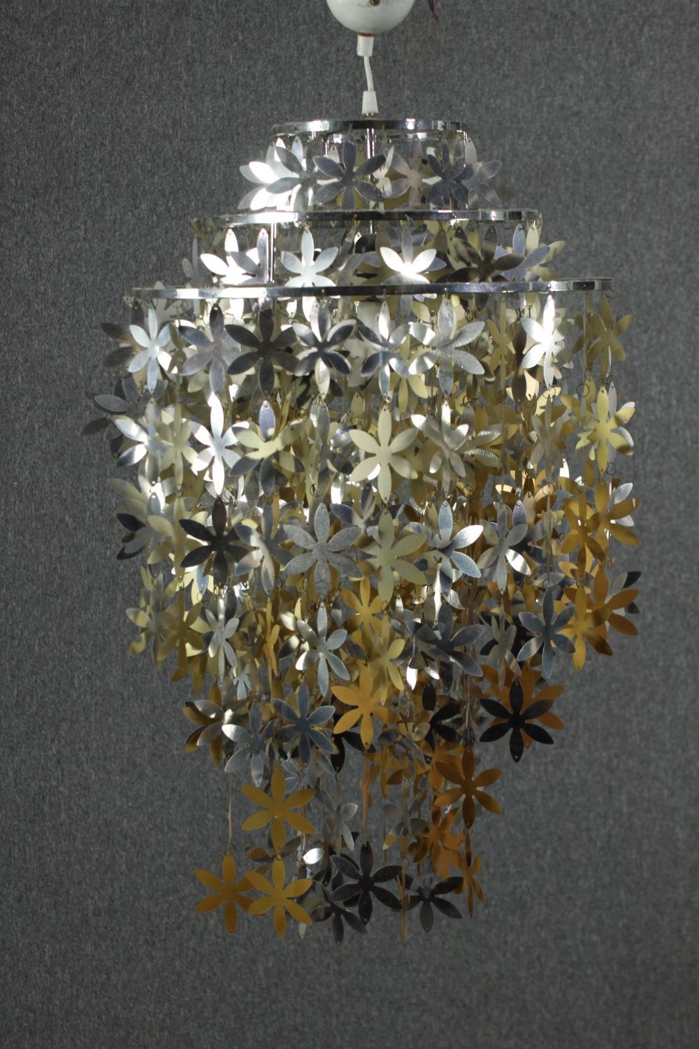 A contemporary gold and silver sheet metal flower waterfall ceiling lamp. H.72 Dia.60cm.