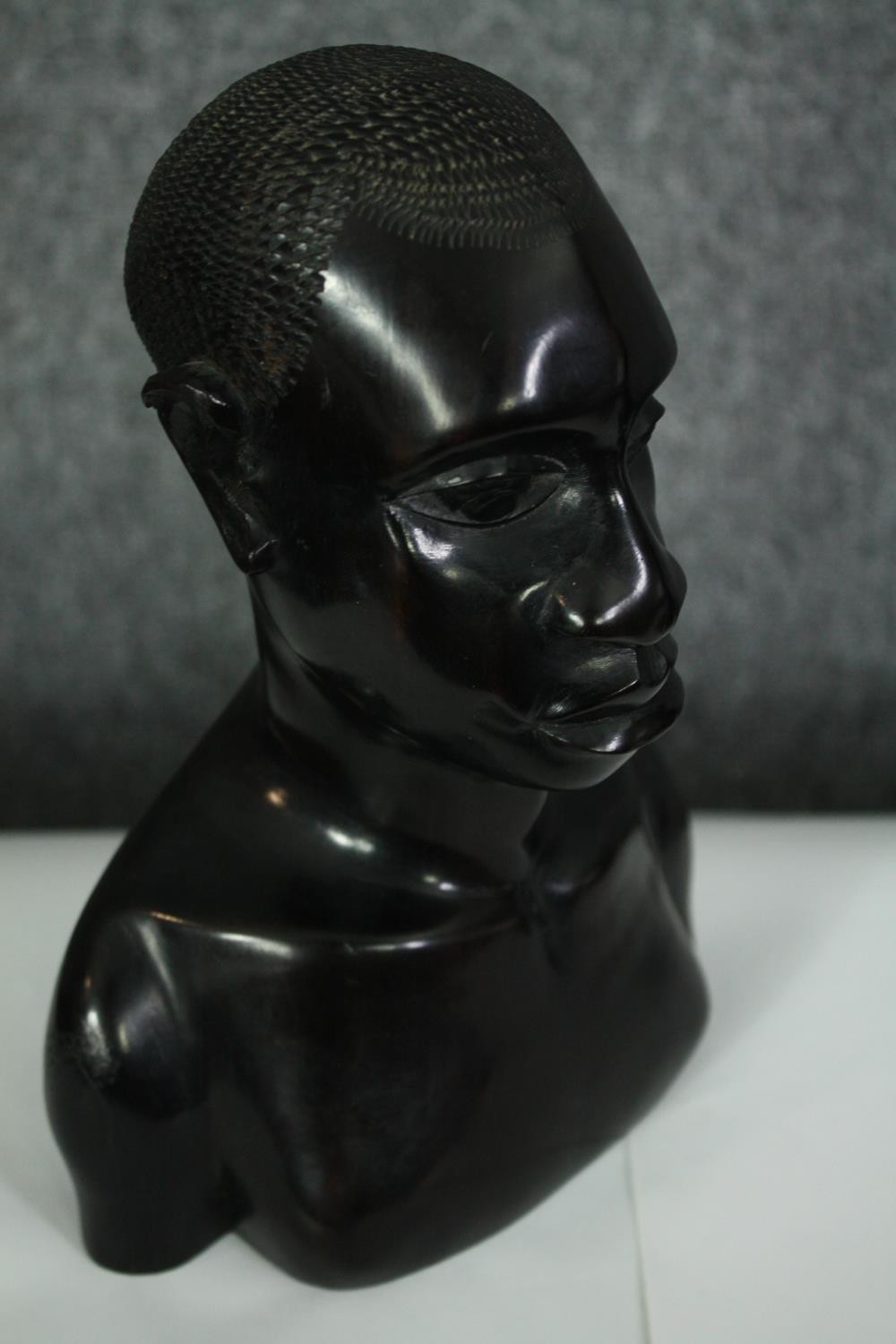 A pair of African carved ebony busts; male and female. H.23cm. (each). - Image 7 of 8