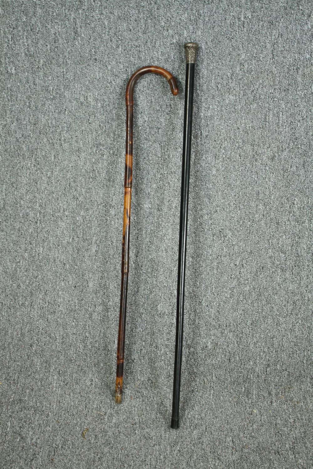 Two walking canes, one with a hallmarked silver handle. L.90cm. (largest)