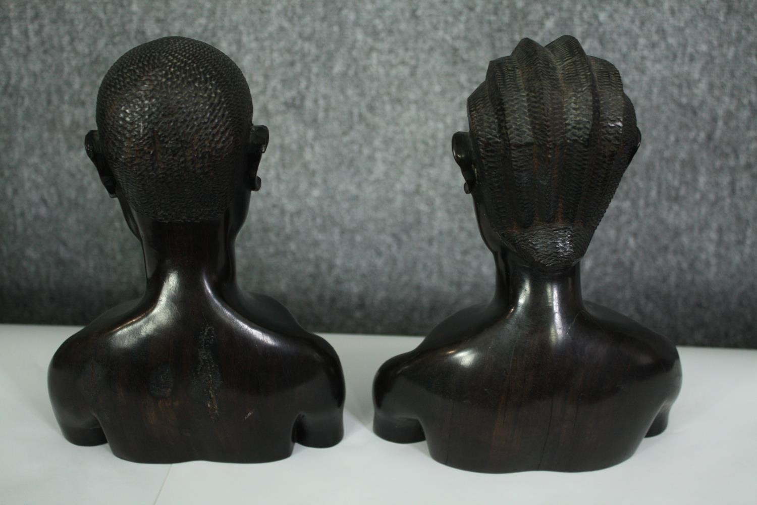 A pair of African carved ebony busts; male and female. H.23cm. (each). - Image 8 of 8