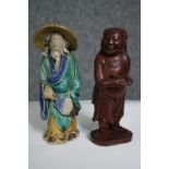 Two Eastern figures, one ceramic the other carved hardwood. H.15cm. (largest).