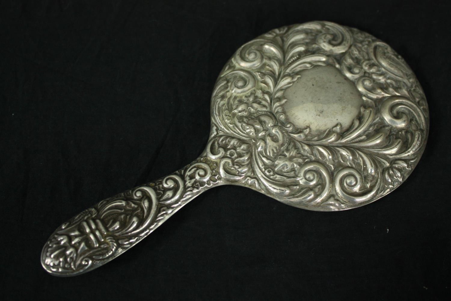 A silver repousse dressing set with foliate and floral design. A mirror and two brushes. Hallmarked: - Image 3 of 5