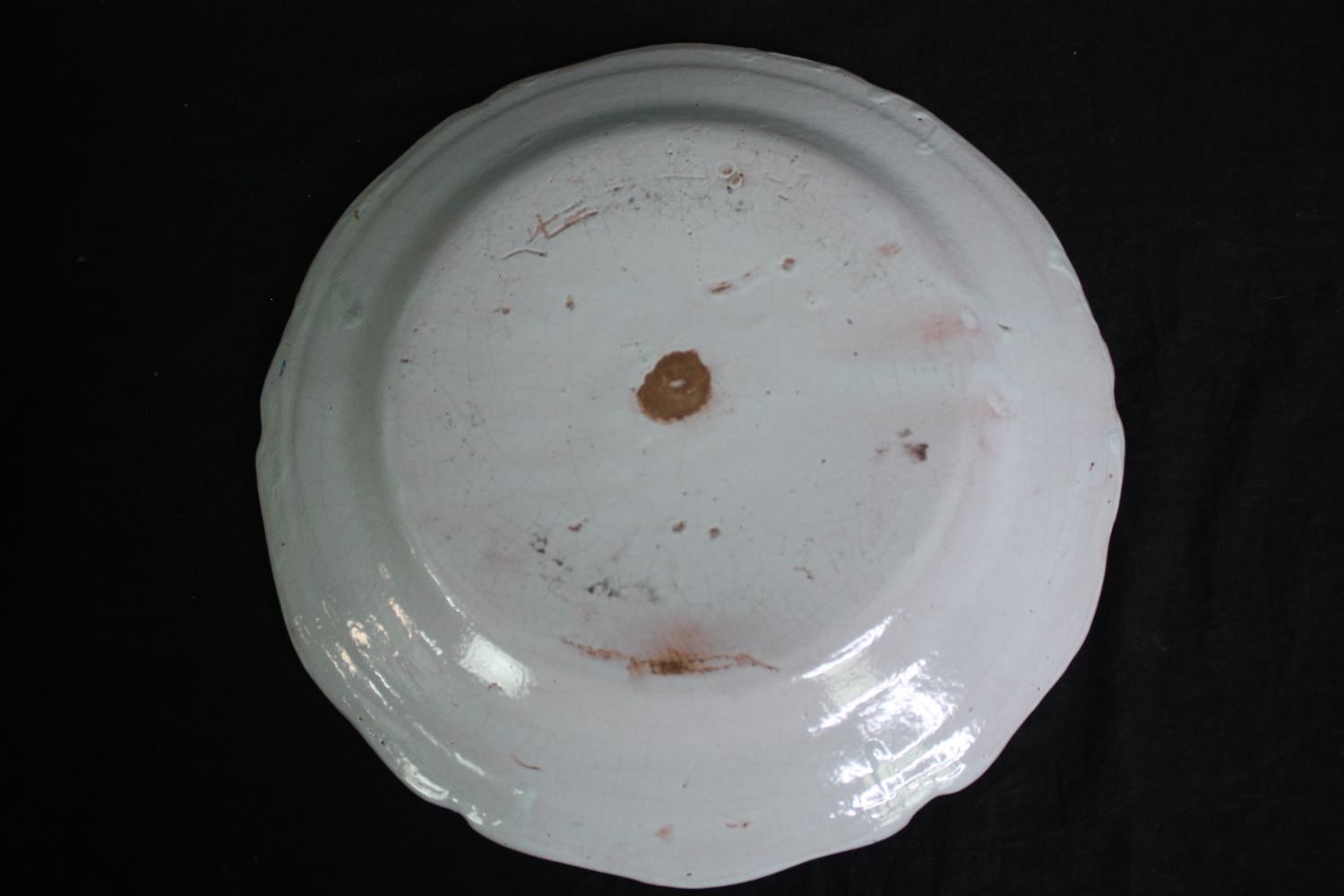 A collection of 19th century faience plates. One damaged. Dia.34cm. (largest). - Image 9 of 11