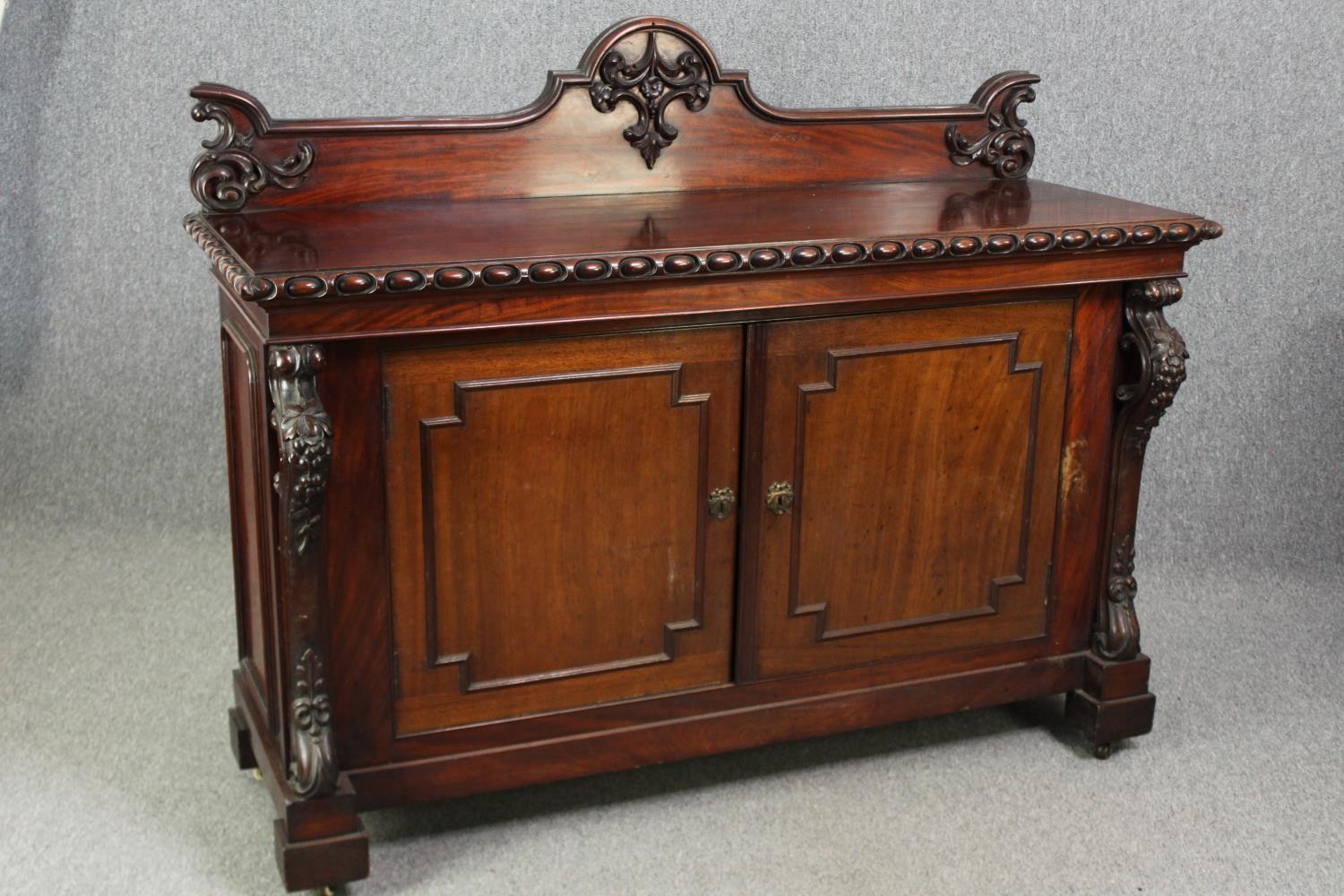 Sideboard, 19th century mahogany with central panelled doors flanked by fruit carved pilasters on - Image 2 of 9