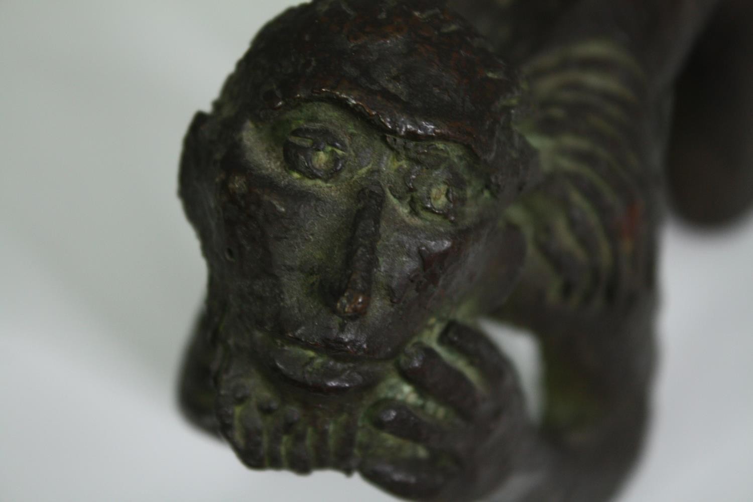 A bronze figure of a crouching man, possibly African. H.10cm. - Image 6 of 6