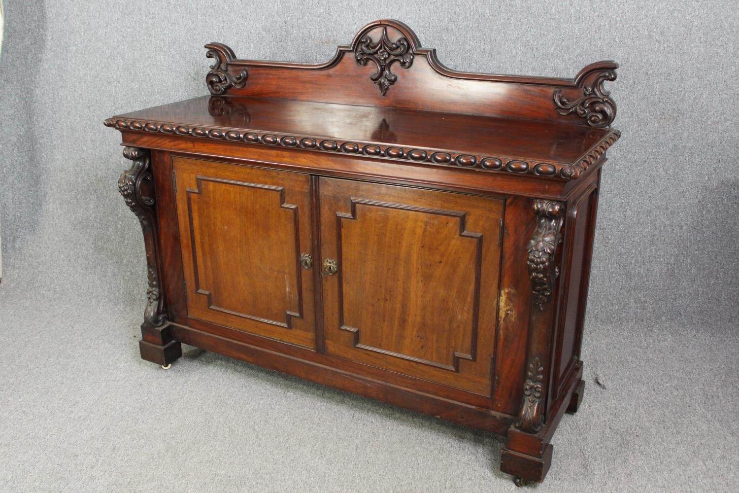 Sideboard, 19th century mahogany with central panelled doors flanked by fruit carved pilasters on - Image 3 of 9
