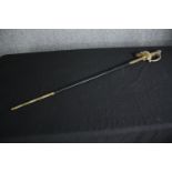 A 19th century officer's dress sword with dress knot and etched blade in brass mounted leather