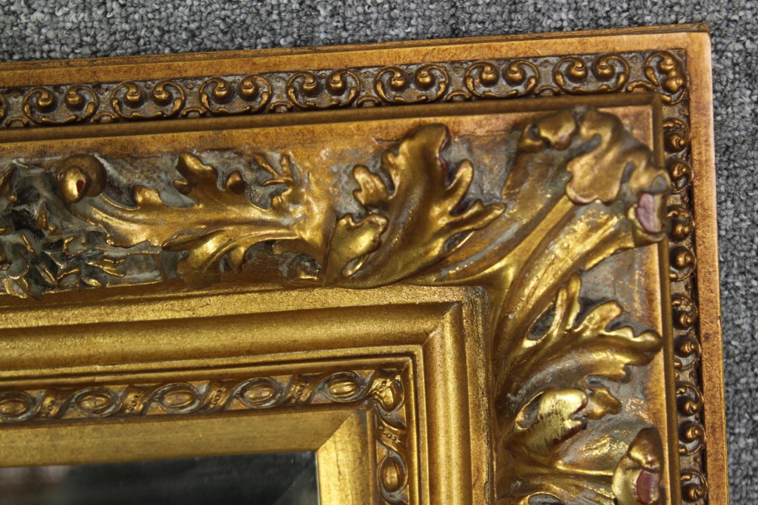 A giltwood and gesso wall mirror with foliate decoration and bevelled plate. H.91 W.120cm. - Image 4 of 7