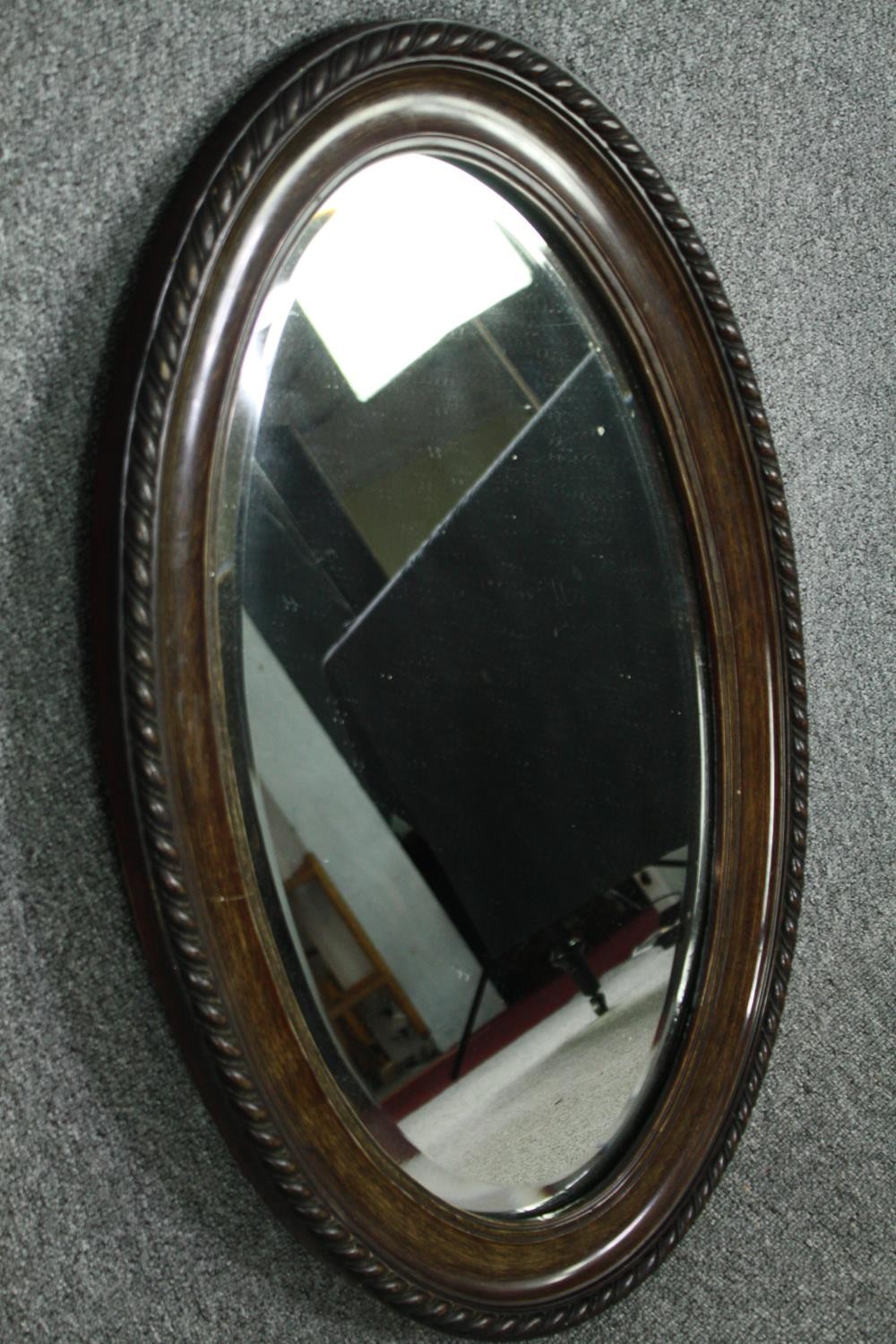 A vintage wall mirror with bevelled plate. H.82 W.52cm. - Image 3 of 5
