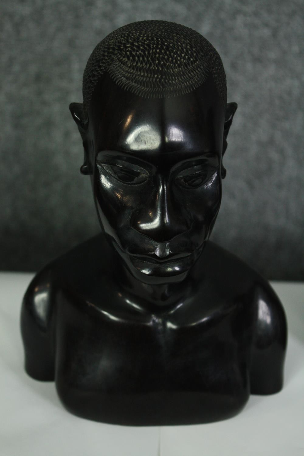 A pair of African carved ebony busts; male and female. H.23cm. (each). - Image 3 of 8