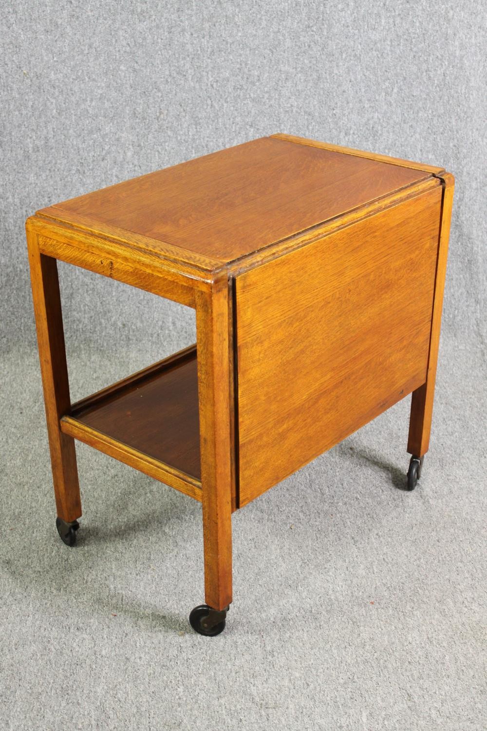 A mid century light oak serving or drinks trolley with spring action drop side. H.66 W.80 D.64cm. - Image 3 of 7