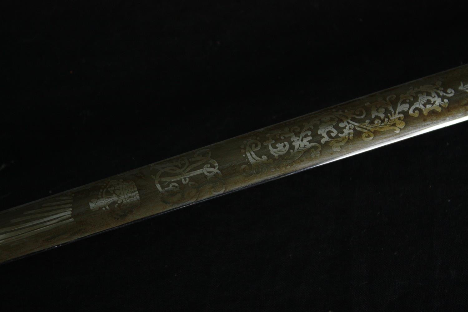 A 19th century officer's dress sword with dress knot and etched blade in brass mounted leather - Image 6 of 6