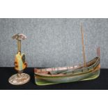 A 1920's vintage hand decorated figure and a scratch built model of a fishing boat. H.29 W.37cm. (