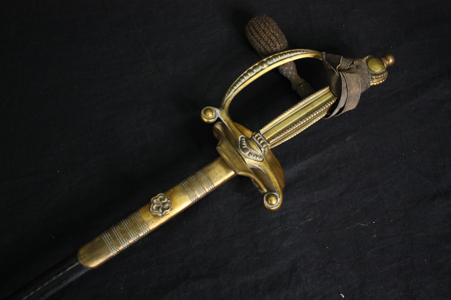 A 19th century officer's dress sword with dress knot and etched blade in brass mounted leather - Image 3 of 6