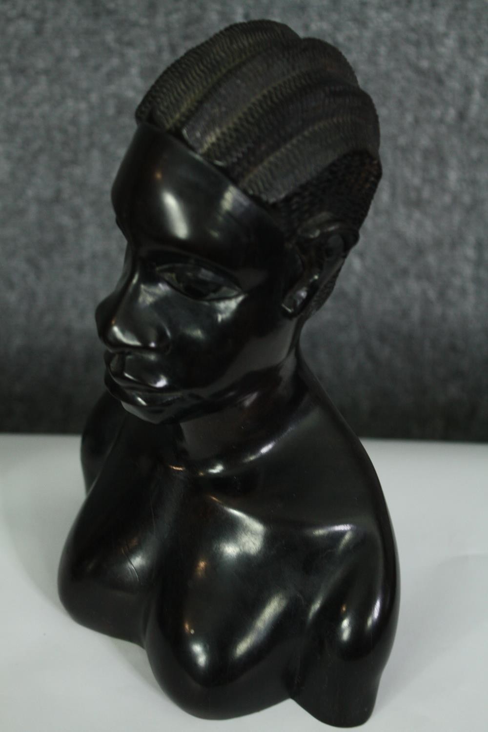 A pair of African carved ebony busts; male and female. H.23cm. (each). - Image 5 of 8