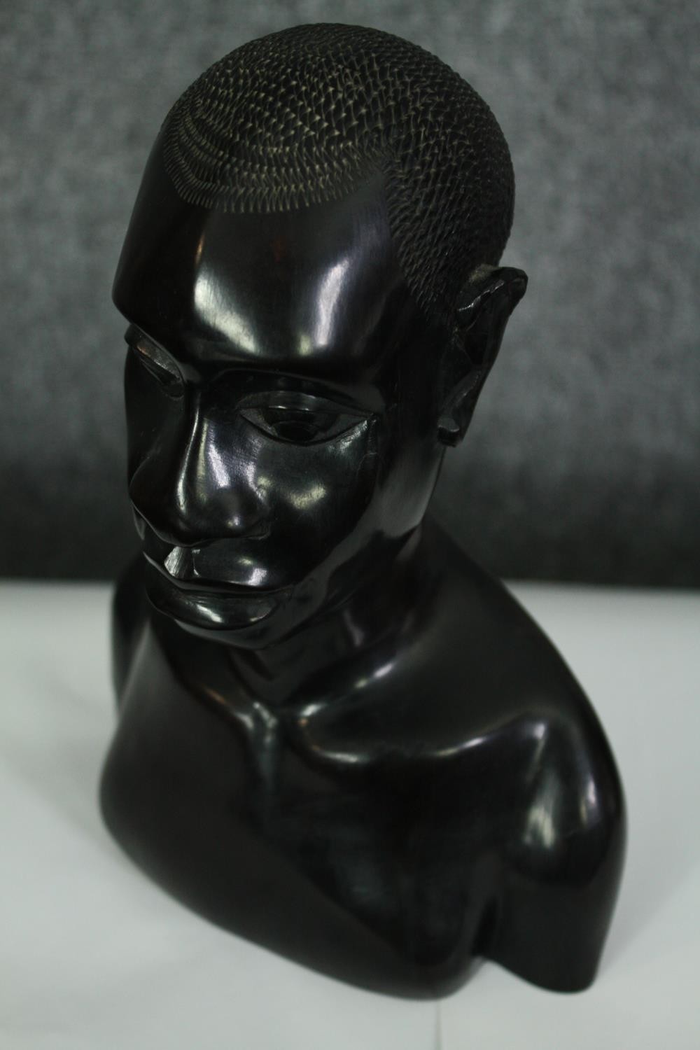 A pair of African carved ebony busts; male and female. H.23cm. (each). - Image 6 of 8