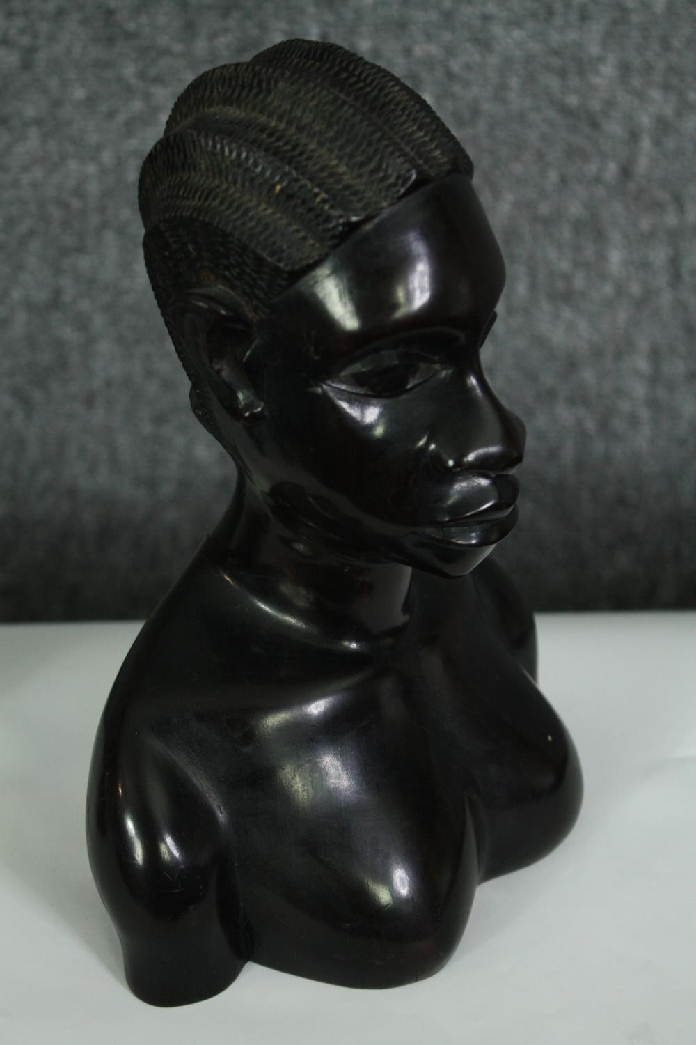 A pair of African carved ebony busts; male and female. H.23cm. (each). - Image 4 of 8