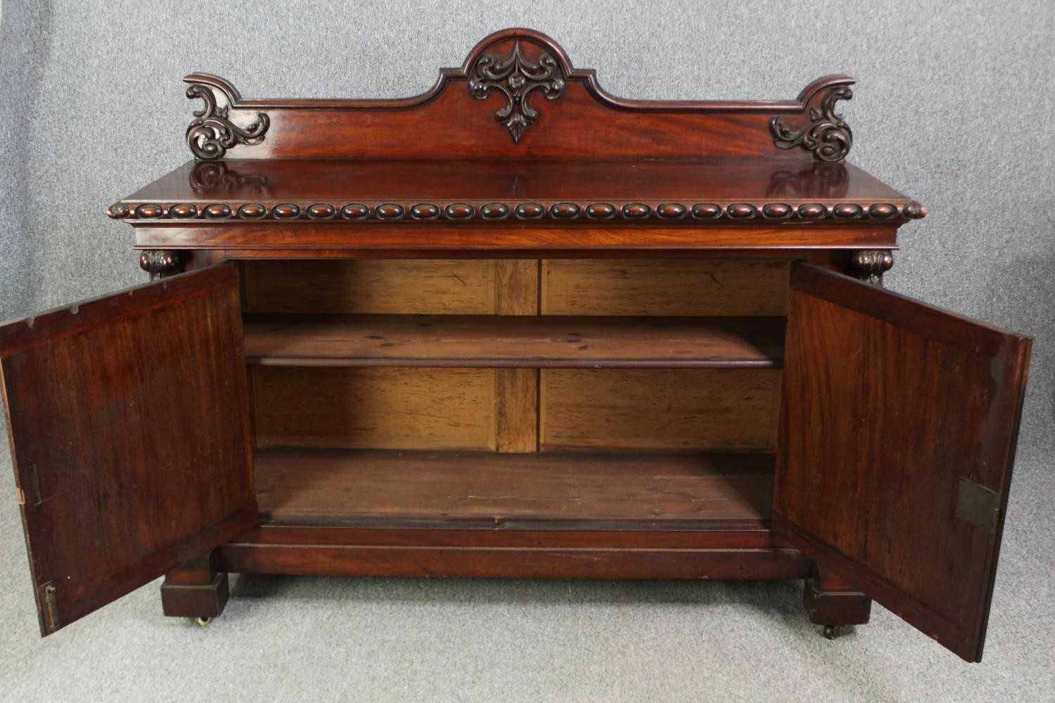 Sideboard, 19th century mahogany with central panelled doors flanked by fruit carved pilasters on - Image 4 of 9