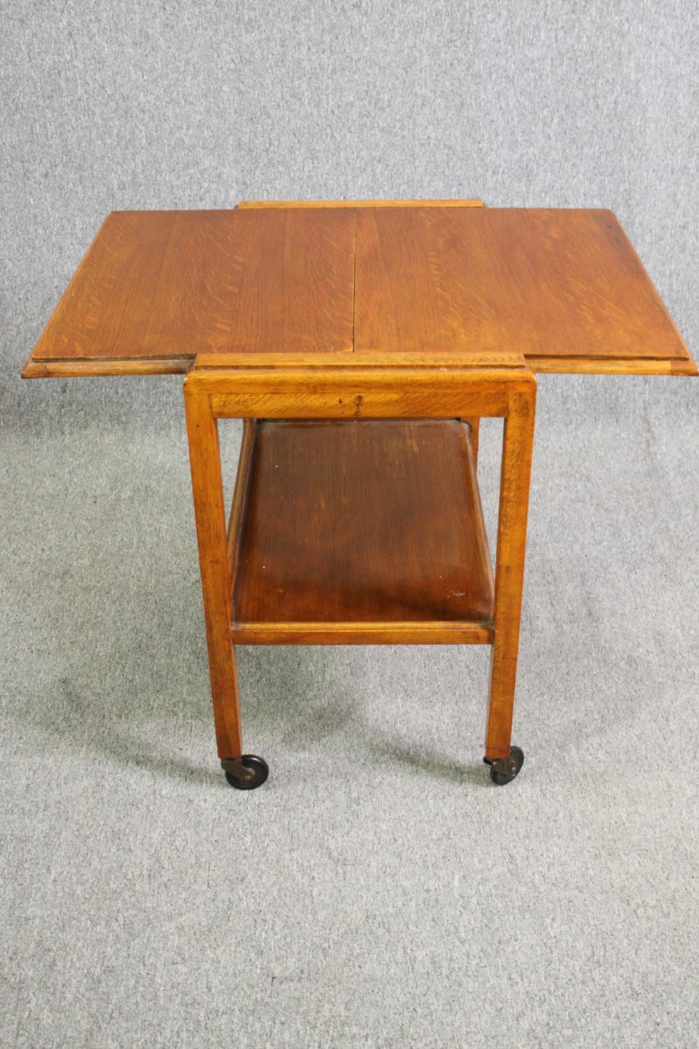 A mid century light oak serving or drinks trolley with spring action drop side. H.66 W.80 D.64cm. - Image 6 of 7