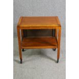 A mid century light oak serving or drinks trolley with spring action drop side. H.66 W.80 D.64cm.