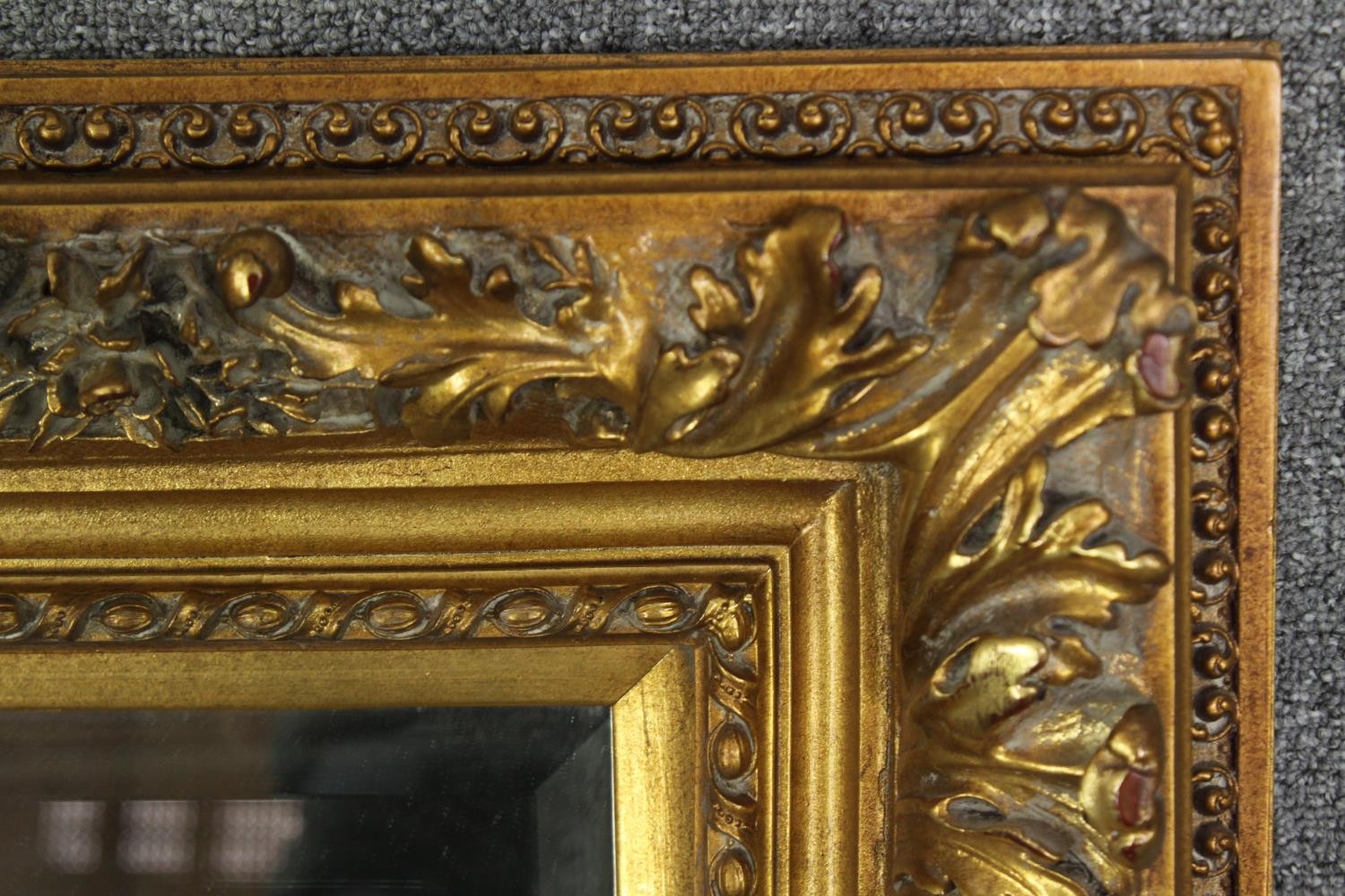 A giltwood and gesso wall mirror with foliate decoration and bevelled plate. H.91 W.120cm. - Image 5 of 7