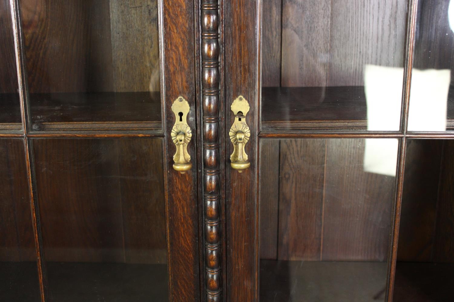 An oak bookcase, mid 20th century, one glass pane is missing. H.209 W.115 D.36cm. - Image 6 of 8