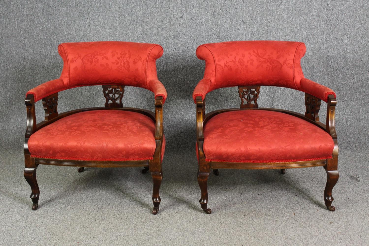A pair of late Victorian walnut salon tub chairs, in red damask upholstery, H.74cm. (each).