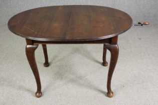 An extending mahogany dining table in George II style, early 20th Century, extra leaf with wind
