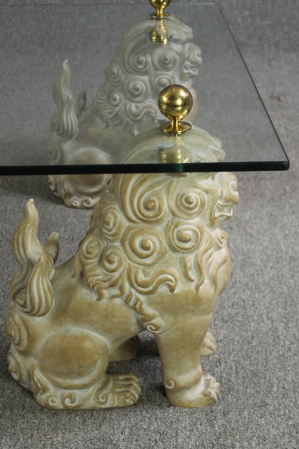 An unusual glass coffee table, with painted fu dog supports, 20th century. H.39 L.152 W.92cm. - Image 5 of 11