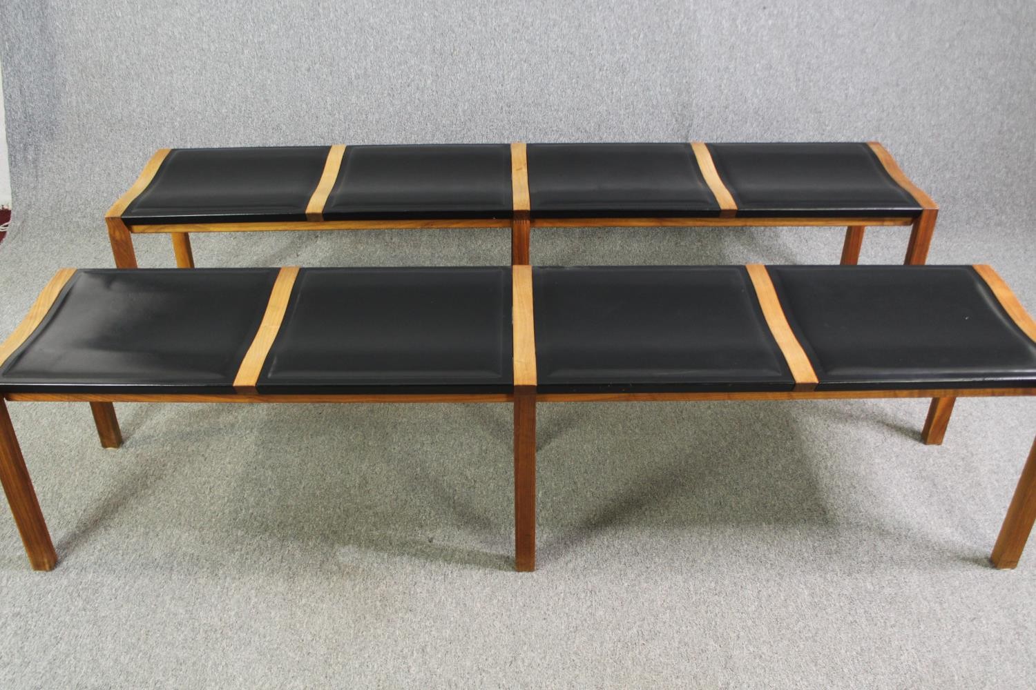 A pair of contemporary Heal's teak and black leather dining benches. H.48 W.200 D.45cm. (each).