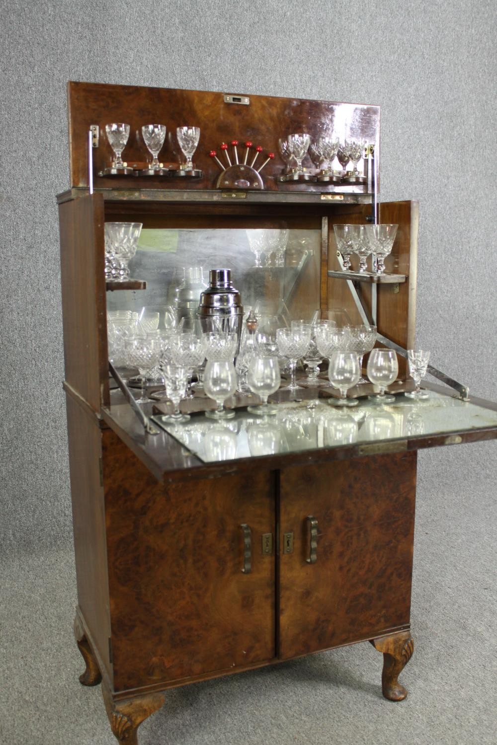 An Art Deco burr walnut cocktail cabinet, circa 1930, enclosing various cut drinking glasses and a - Image 10 of 12