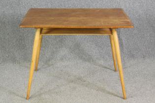 An Ercol light elm side table, with an undertier on beech supports. H.74 W.98 D.68cm.
