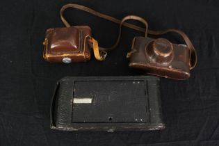 Three vintage cameras by Leica, Kodak and Paxette. H.12 W.25cm. (largest).