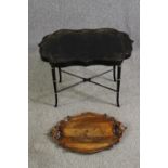 A Victorian papier mâché tray on later ebonized stand, along with a carved walnut tray. H.54 W.82