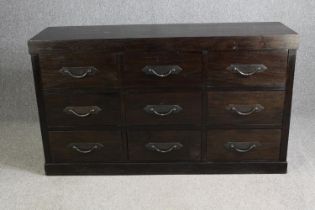 An Eastern hardwood chest of nine drawers. H.90 W.157 D.46cm.