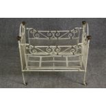 A white painted metal and brass cot, early 20th century. H.64 W.69 D.38cm.