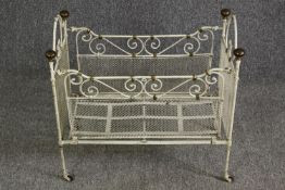 A white painted metal and brass cot, early 20th century. H.64 W.69 D.38cm.