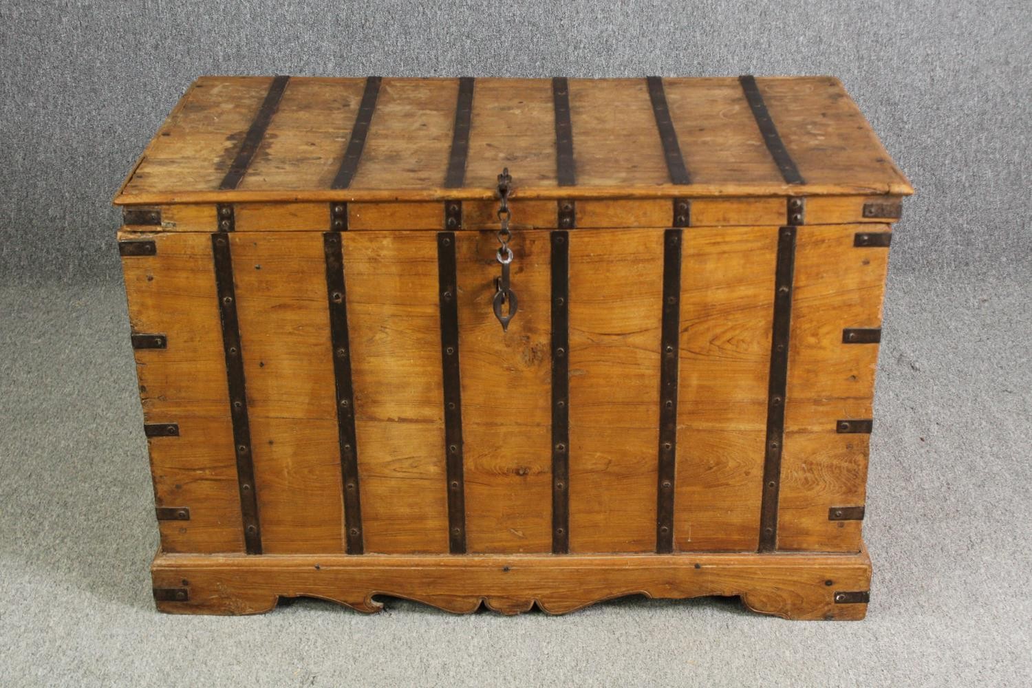 A continental pitch pine and metal bound lidded chest, probably 19th century, H.70 W.110 D.60cm.