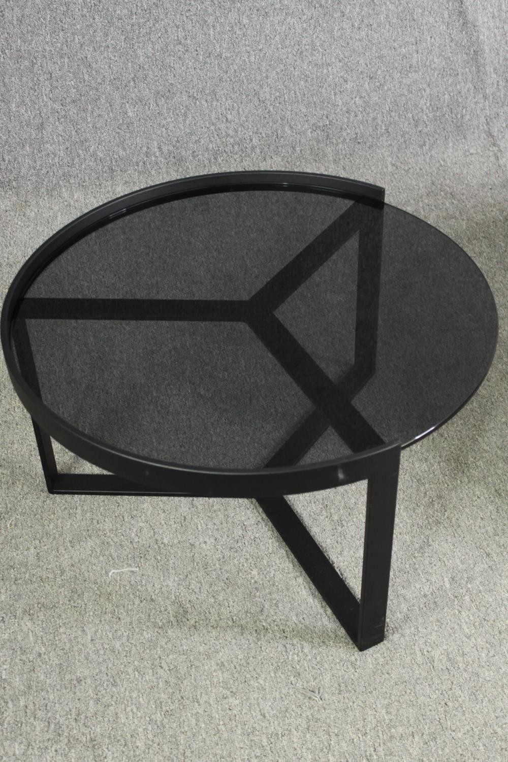 Two contemporary coffee tables with tinted glass tops and black metal supports. H.35 Dia.89cm. ( - Image 6 of 10