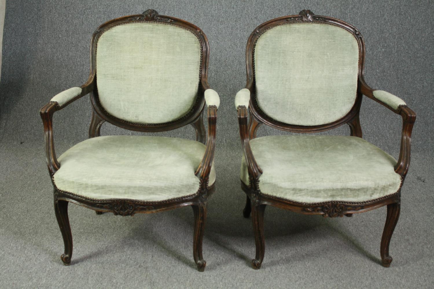 Armchairs, a pair, 19th century carved mahogany fauteuil on cabriole supports.