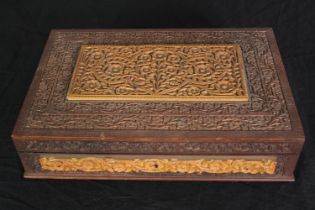 A Mah Jong set in a carved wooden case, with instructions, H.7 W.30 D.20cm.